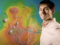 Andrew Hanna with a map of mars topography